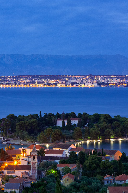 Preko and Zadar in evening blue hour seen from island Ugljan, Da